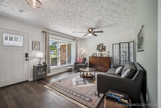 1120 S Sequoyah Dr, Oologah, OK 74053 - living room featuring dark wood-style floors, a textured ceiling, and a ceiling fan