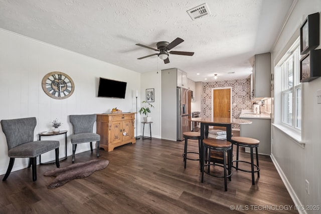 1120 S Sequoyah Dr, Oologah, OK 74053 - dining area with a textured ceiling, ceiling fan, and dark wood-type flooring