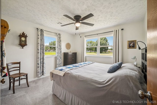 1120 S Sequoyah Dr, Oologah, OK 74053 - carpeted bedroom with a textured ceiling and a ceiling fan