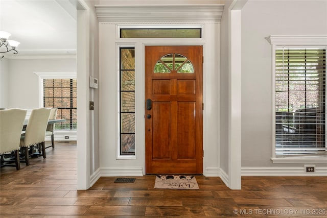 5428 E 88th St, Tulsa, OK 74137 - entrance foyer featuring ornamental molding, dark wood-type flooring, plenty of natural light, and a chandelier