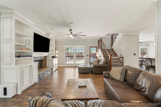 5428 E 88th St, Tulsa, OK 74137 - living area featuring a ceiling fan, dark wood finished floors, a tiled fireplace, stairs, and ornamental molding