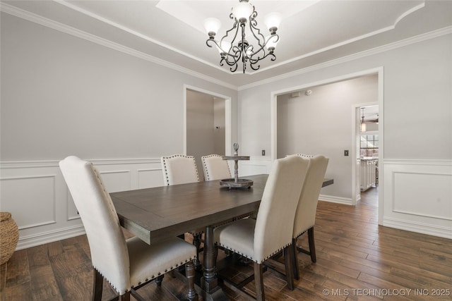 5428 E 88th St, Tulsa, OK 74137 - dining room featuring a chandelier, dark wood-style flooring, a decorative wall, crown molding, and a wainscoted wall