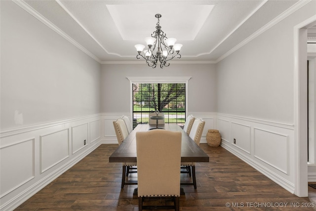 5428 E 88th St, Tulsa, OK 74137 - dining space with a tray ceiling, a chandelier, dark wood-style floors, a decorative wall, and wainscoting