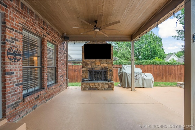 5428 E 88th St, Tulsa, OK 74137 - fenced backyard featuring an outdoor stone fireplace, a patio area, and ceiling fan