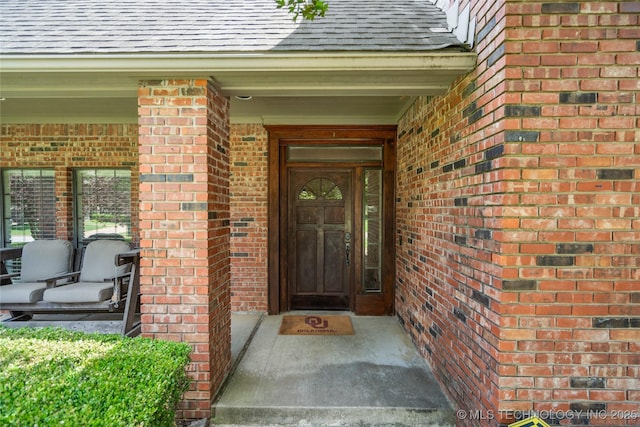 5428 E 88th St, Tulsa, OK 74137 - view of exterior entry with brick siding and a shingled roof