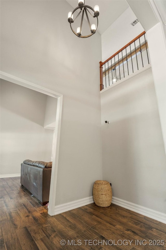 5428 E 88th St, Tulsa, OK 74137 - staircase featuring wood finished floors, a chandelier, and a towering ceiling