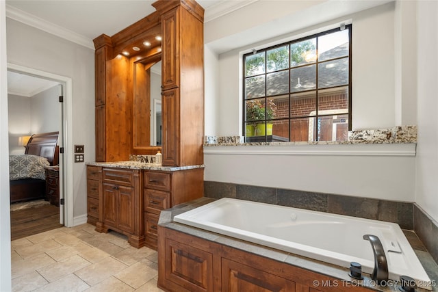 5428 E 88th St, Tulsa, OK 74137 - ensuite bathroom featuring vanity, a garden tub, ornamental molding, and stone finish flooring