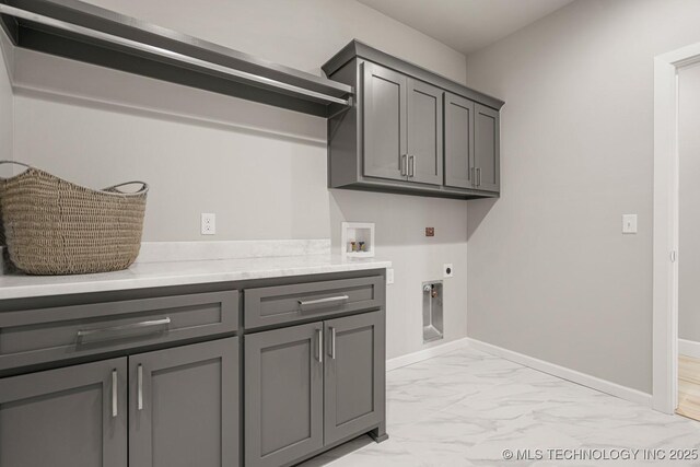3905 S Elder Blvd, Broken Arrow, OK 74012 - washroom featuring hookup for an electric dryer, cabinet space, light marble finish floors, and washer hookup