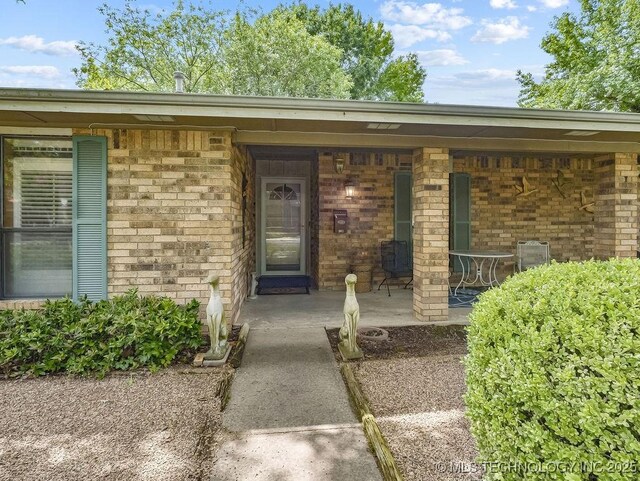 301 S Byrd, Coalgate, OK 74538 - property entrance featuring brick siding and covered porch