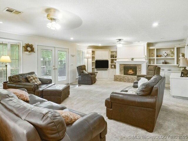 301 S Byrd, Coalgate, OK 74538 - carpeted living room with a ceiling fan, ornamental molding, a brick fireplace, french doors, and recessed lighting