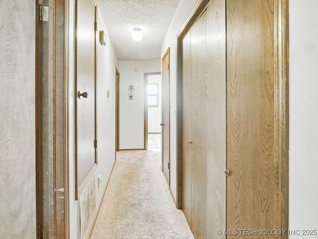 301 S Byrd, Coalgate, OK 74538 - hall featuring a textured ceiling and carpet