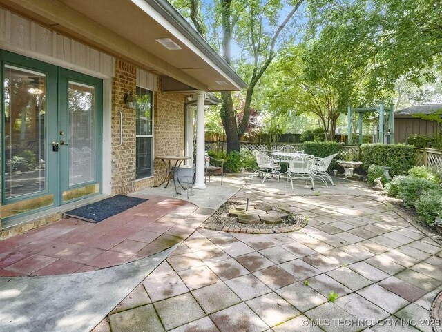 301 S Byrd, Coalgate, OK 74538 - fenced backyard featuring french doors, a patio area, and outdoor dining space