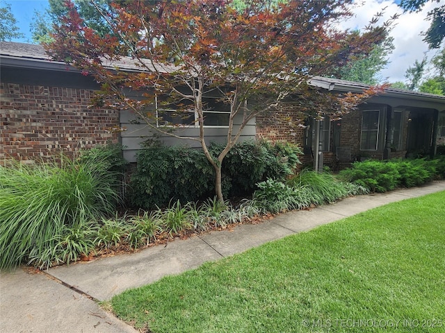 5135 S Marion Pl, Tulsa, OK 74135 - view of home's exterior featuring brick siding and a yard