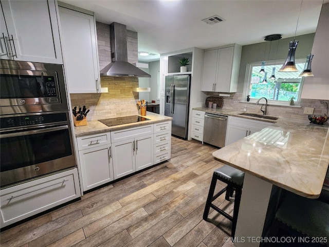 5135 S Marion Pl, Tulsa, OK 74135 - kitchen with stainless steel appliances, wall chimney exhaust hood, backsplash, and light stone counters