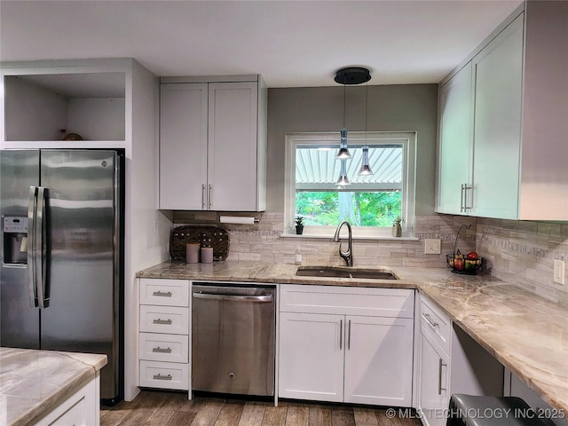 5135 S Marion Pl, Tulsa, OK 74135 - kitchen featuring appliances with stainless steel finishes, wood finished floors, tasteful backsplash, and hanging light fixtures