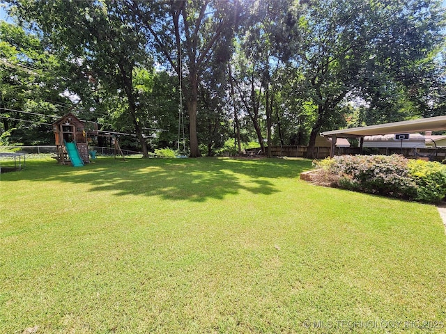 5135 S Marion Pl, Tulsa, OK 74135 - view of yard featuring a playground and view of wooded area