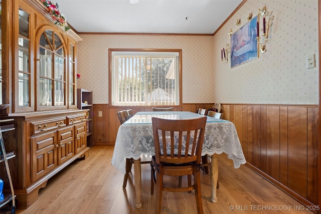 507 S Thompson, Vinita, OK 74301 - dining room with crown molding, wainscoting, light wood-type flooring, and wood walls