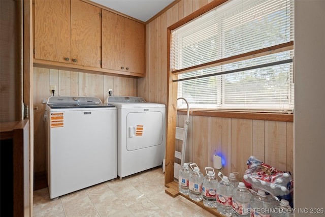 507 S Thompson, Vinita, OK 74301 - washroom featuring separate washer and dryer, cabinet space, and wood walls