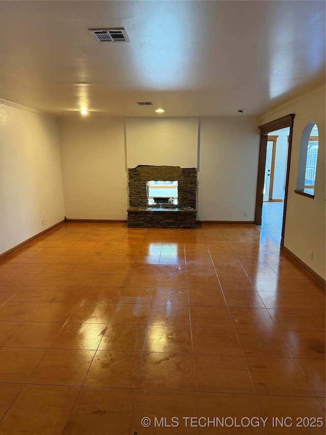 5616 S 91st E Ave, Tulsa, OK 74145 - unfurnished living room with a stone fireplace, tile patterned flooring, ornamental molding, and recessed lighting