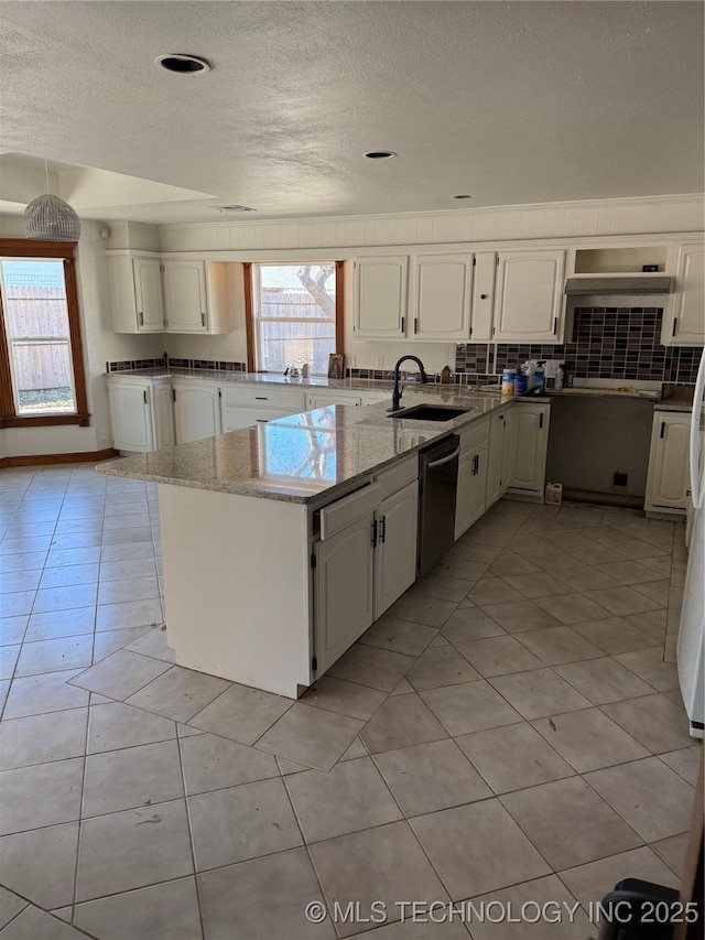 5616 S 91st E Ave, Tulsa, OK 74145 - kitchen featuring stainless steel dishwasher, a textured ceiling, plenty of natural light, light stone counters, and white cabinets