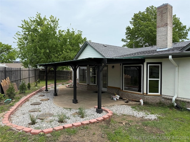 5616 S 91st E Ave, Tulsa, OK 74145 - rear view of house featuring a patio area, a chimney, a shingled roof, and brick siding
