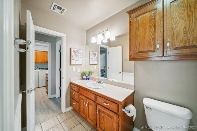 12708 E 78th St, Owasso, OK 74055 - bathroom with washer and clothes dryer, vanity, and tile patterned floors