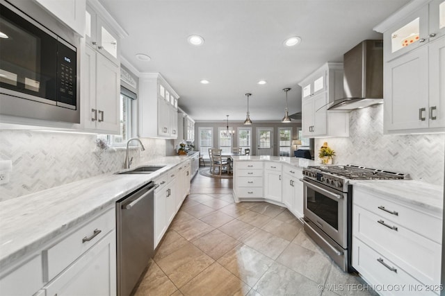 12708 E 78th St, Owasso, OK 74055 - kitchen with appliances with stainless steel finishes, wall chimney exhaust hood, recessed lighting, white cabinets, and backsplash