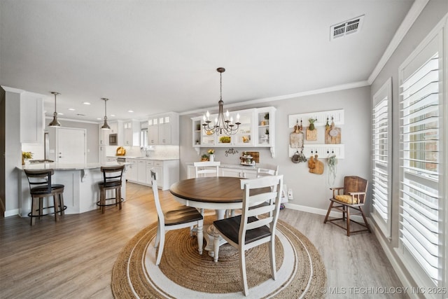 12708 E 78th St, Owasso, OK 74055 - dining space featuring light wood-style floors, ornamental molding, a chandelier, and recessed lighting