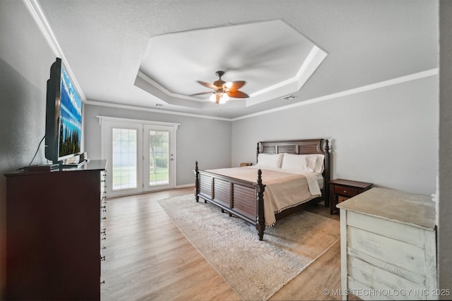 12708 E 78th St, Owasso, OK 74055 - bedroom featuring a tray ceiling, crown molding, light wood finished floors, access to exterior, and a ceiling fan