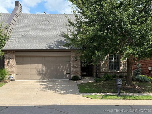 11025 E 83rd St, Tulsa, OK 74133 - view of front of property with driveway, a garage, brick siding, and a shingled roof