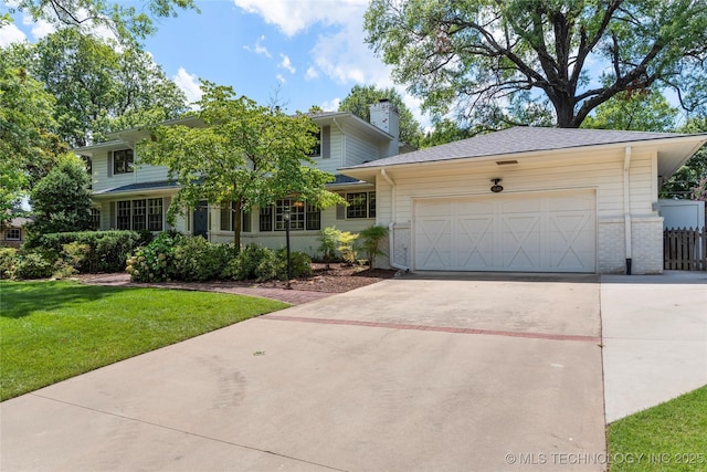 4146 S Birmingham Pl, Tulsa, OK 74105 - view of front of property featuring concrete driveway, a chimney, and a garage