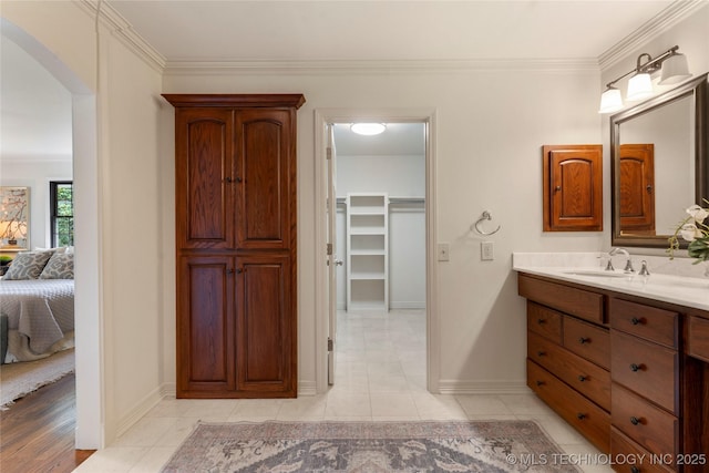 4146 S Birmingham Pl, Tulsa, OK 74105 - full bath featuring vanity, crown molding, a spacious closet, connected bathroom, and tile patterned flooring