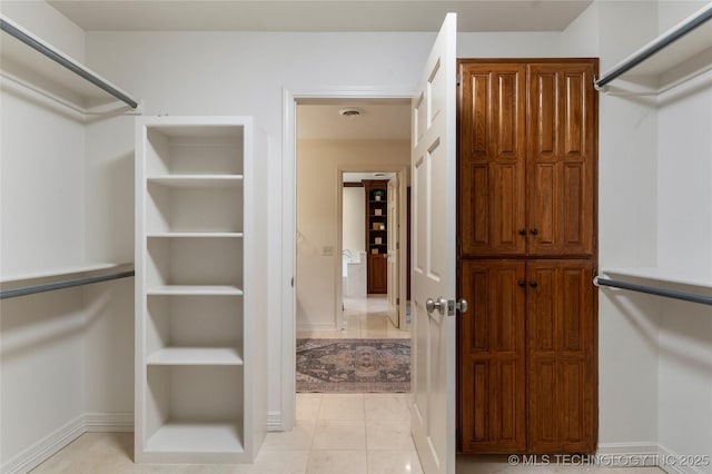 4146 S Birmingham Pl, Tulsa, OK 74105 - spacious closet featuring light tile patterned floors
