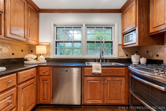 4146 S Birmingham Pl, Tulsa, OK 74105 - kitchen featuring stainless steel appliances, brown cabinets, ornamental molding, backsplash, and dark wood finished floors