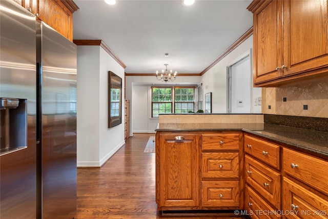 4146 S Birmingham Pl, Tulsa, OK 74105 - kitchen with stainless steel fridge, brown cabinets, ornamental molding, tasteful backsplash, and a peninsula