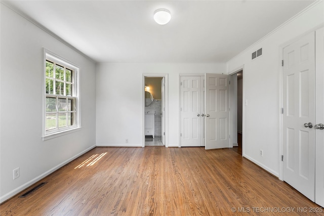 4146 S Birmingham Pl, Tulsa, OK 74105 - unfurnished bedroom with wood finished floors, ensuite bath, and ornamental molding