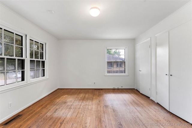 4146 S Birmingham Pl, Tulsa, OK 74105 - unfurnished bedroom with light wood-style flooring and crown molding