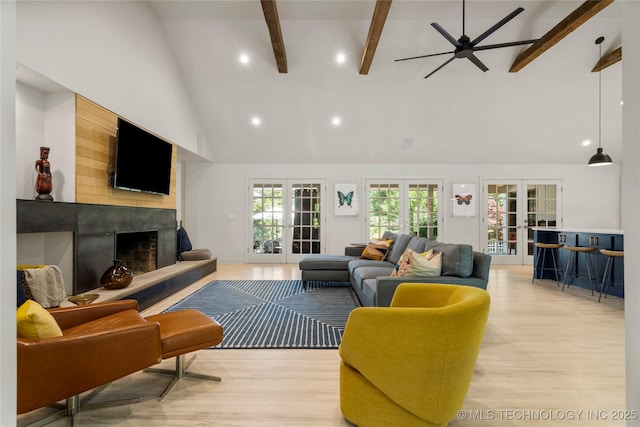 3918 S Evanston Ave, Tulsa, OK 74105 - living area featuring high vaulted ceiling, a high end fireplace, beam ceiling, light wood finished floors, and ceiling fan