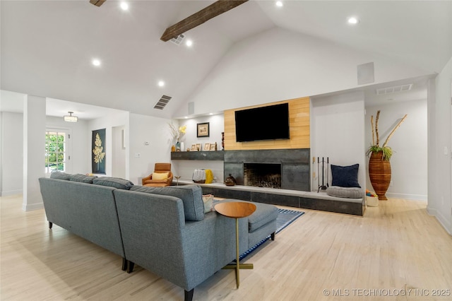 3918 S Evanston Ave, Tulsa, OK 74105 - living room with light wood-type flooring, high vaulted ceiling, a tiled fireplace, and recessed lighting