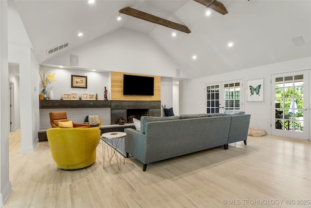 3918 S Evanston Ave, Tulsa, OK 74105 - living room with wood finished floors, high vaulted ceiling, a fireplace, and recessed lighting