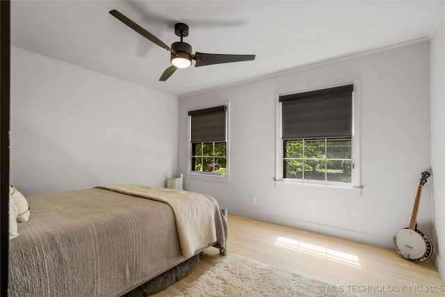 3918 S Evanston Ave, Tulsa, OK 74105 - bedroom with wood finished floors, ornamental molding, and a ceiling fan