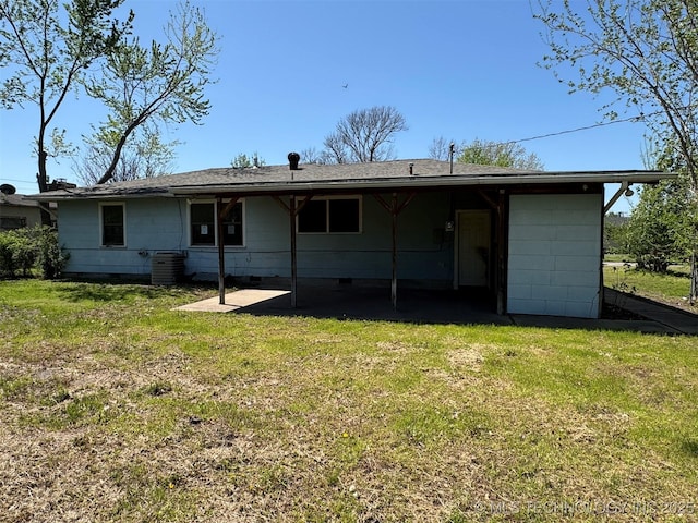 611 Crutchmer Ave, Okmulgee, OK 74447 - back of house with crawl space, a yard, a shingled roof, and a patio