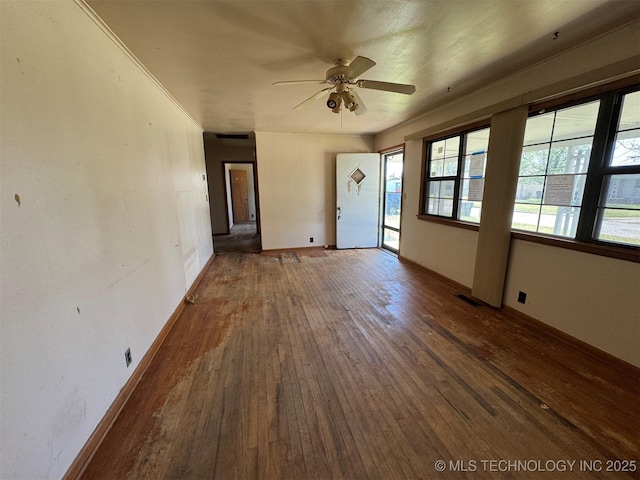 611 Crutchmer Ave, Okmulgee, OK 74447 - unfurnished living room featuring hardwood / wood-style flooring and a ceiling fan