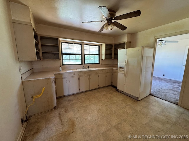 611 Crutchmer Ave, Okmulgee, OK 74447 - kitchen featuring open shelves, white fridge with ice dispenser, and a ceiling fan