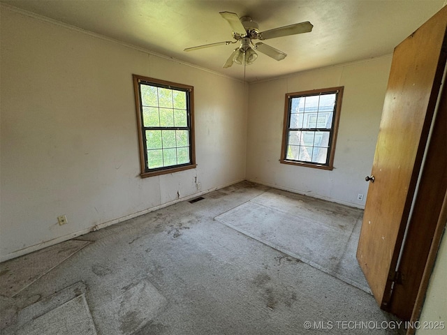 611 Crutchmer Ave, Okmulgee, OK 74447 - spare room with carpet floors, a ceiling fan, and crown molding