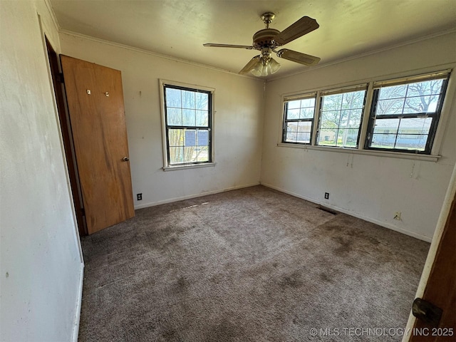 611 Crutchmer Ave, Okmulgee, OK 74447 - empty room featuring carpet, ceiling fan, and crown molding