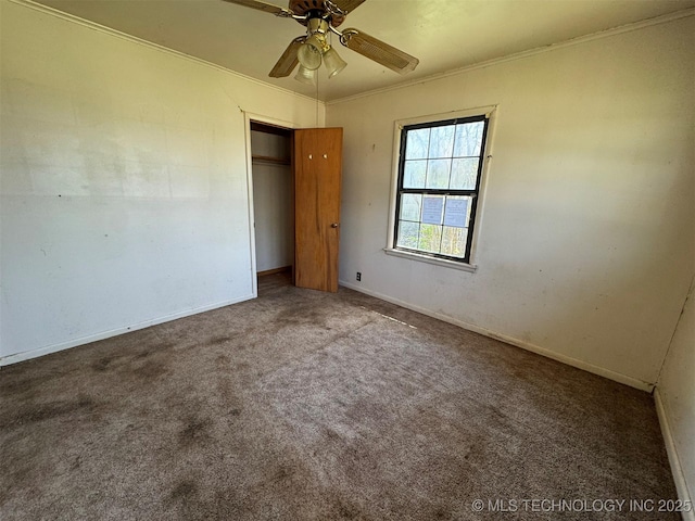 611 Crutchmer Ave, Okmulgee, OK 74447 - unfurnished bedroom featuring carpet, crown molding, a closet, and a ceiling fan