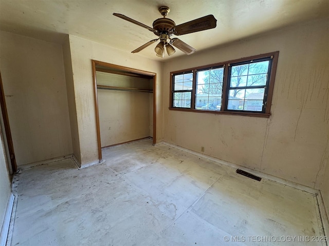 611 Crutchmer Ave, Okmulgee, OK 74447 - unfurnished bedroom with a closet, concrete flooring, and ceiling fan