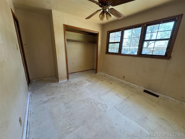 611 Crutchmer Ave, Okmulgee, OK 74447 - unfurnished bedroom featuring a closet, unfinished concrete floors, and a ceiling fan