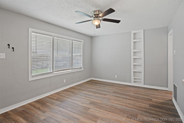 345 N Pine, Dewey, OK 74029 - spare room with ceiling fan, a textured ceiling, and wood finished floors